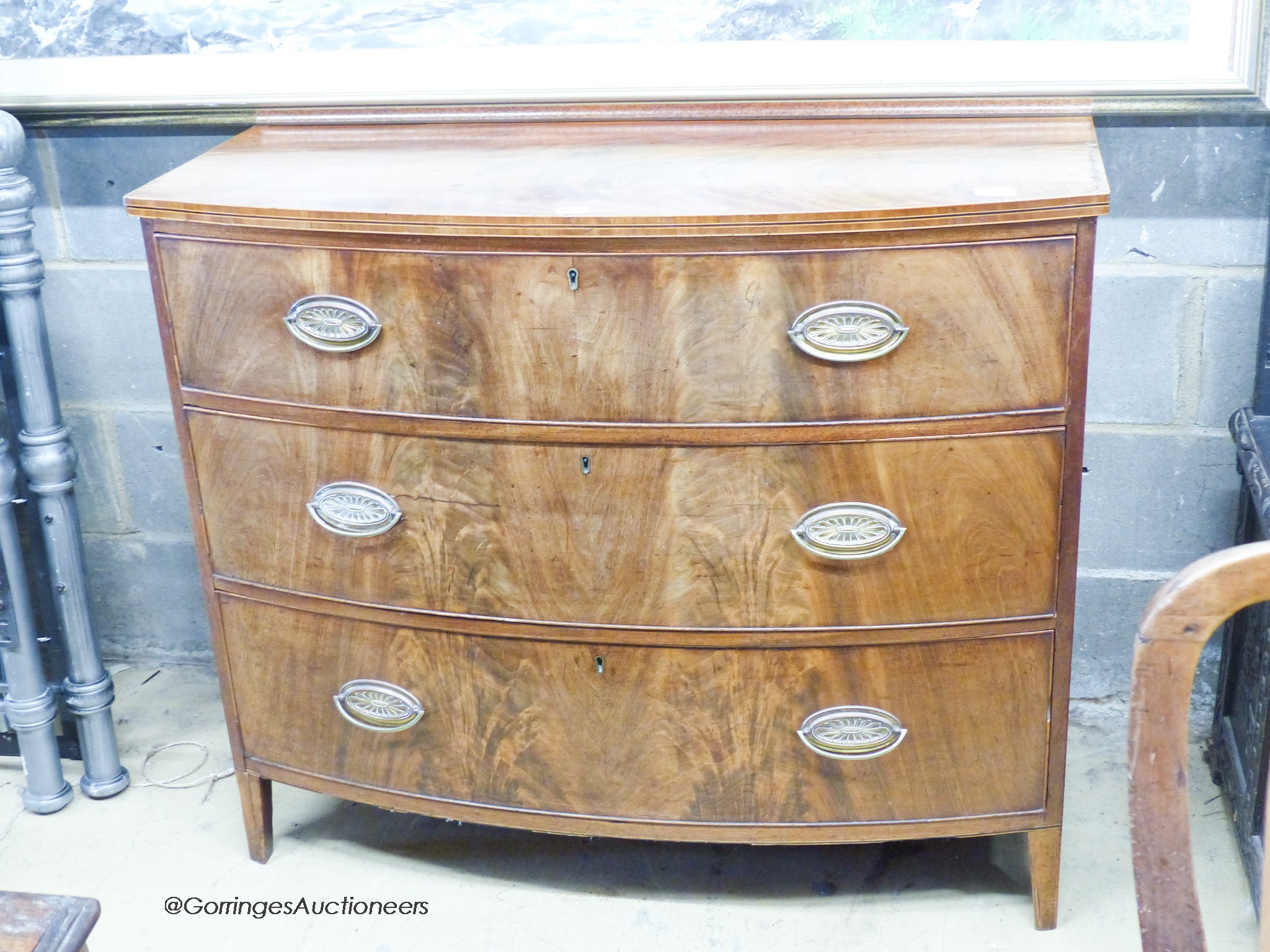 A Regency banded mahogany bow fronted three drawer chest of drawers, W.109cm D.53cm H.92cm